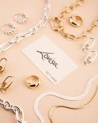 a collection of gold and silver jewelry on a table